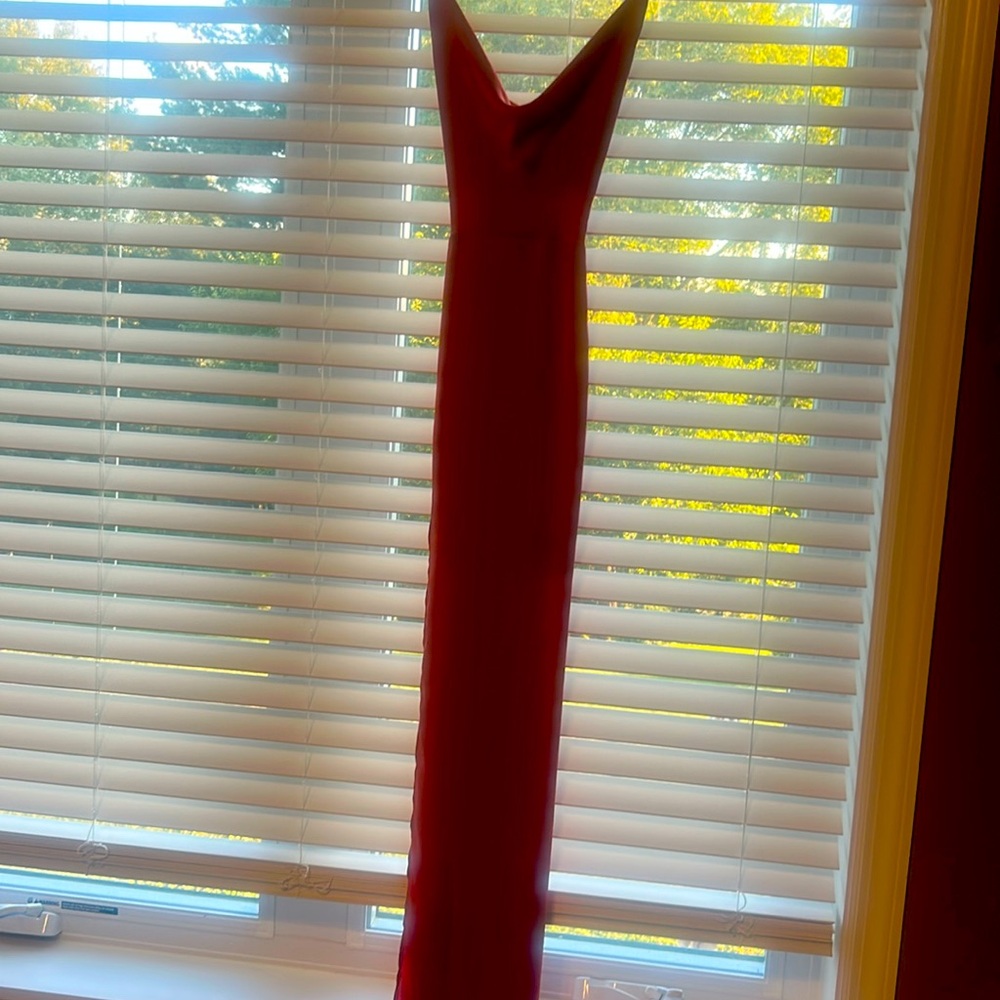 Beautiful rust silky maxi dress. Back zipper  and criss cross straps side slit